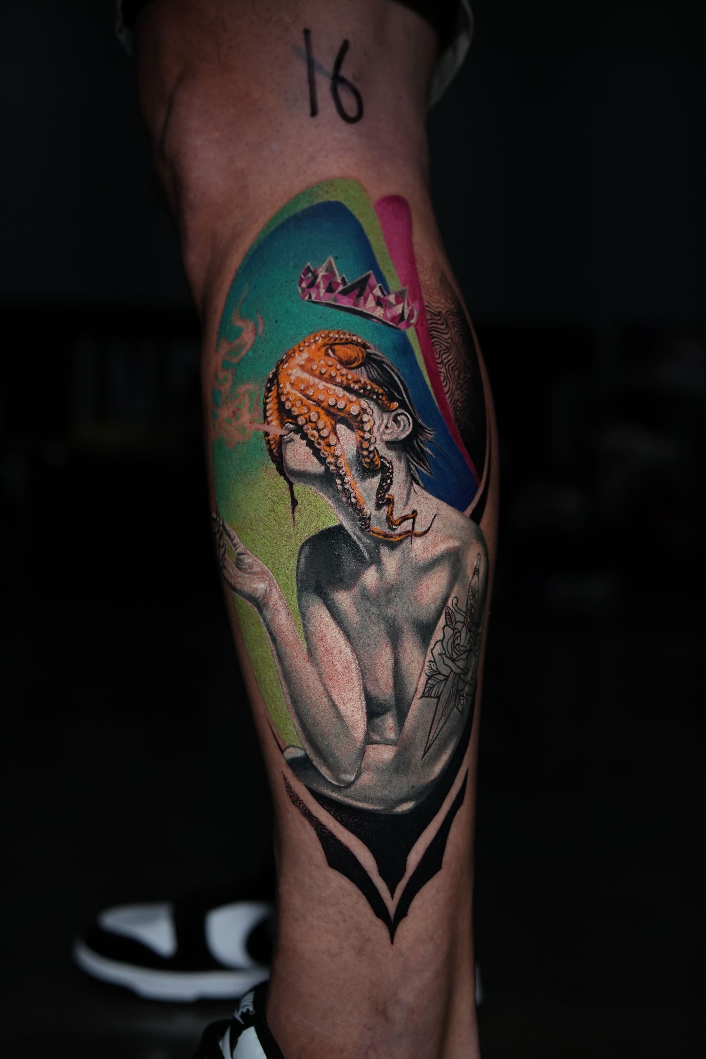 Surrealist color tattoo of a figure crowned by an octopus, on the calf, by Rivas Indeed in San Juan, Puerto Rico
